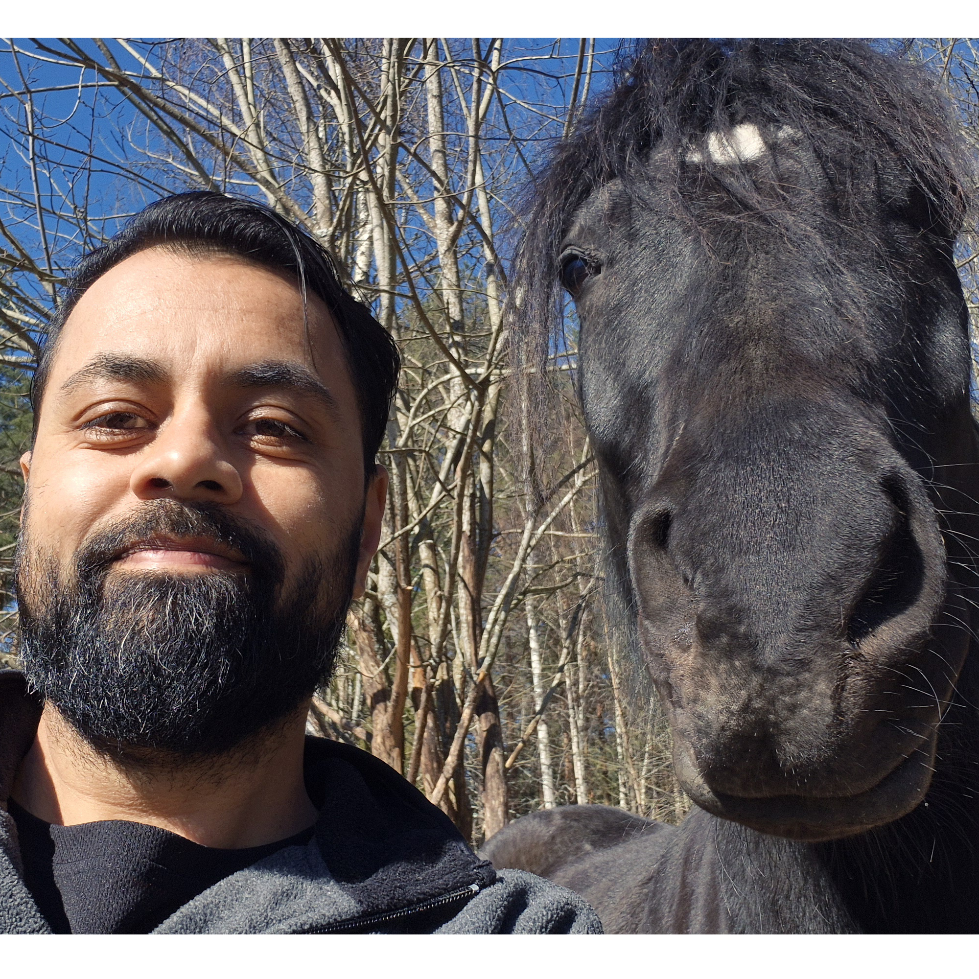 Salim outdoors with a horse